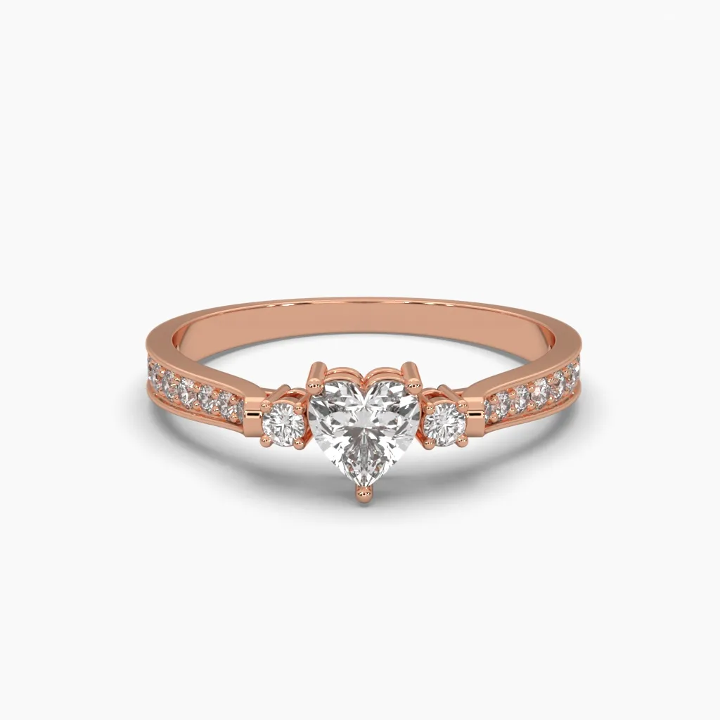 Anillo oro rosa14k con circonia de corazon en el centro y circonias redondas laterales.
