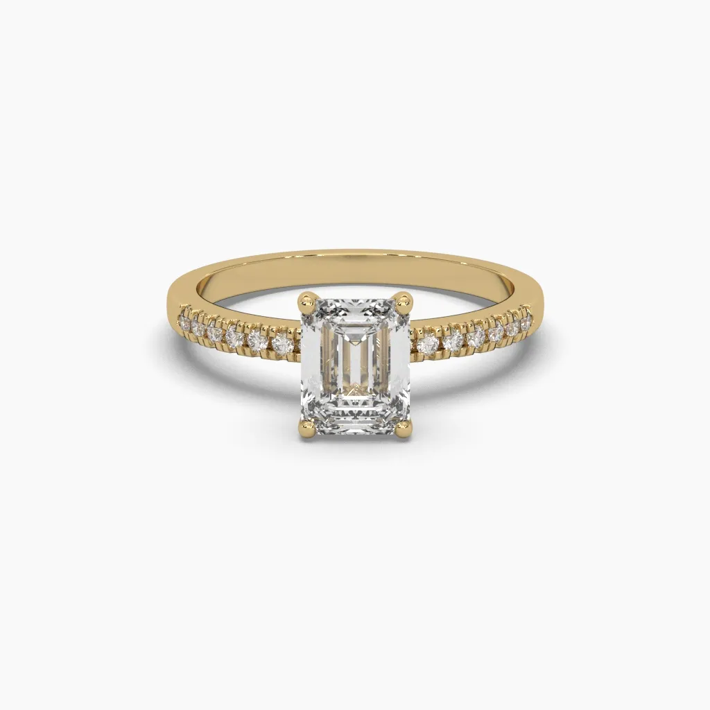 Anillo oro amarillo 14k con circonia corte esmeralda y brazo con circonias redonda.